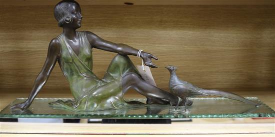 An Art Deco spelter figure of a seated woman with mirror base length 65.5cm